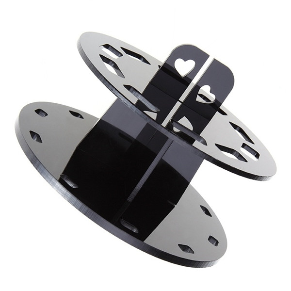 Porta pennelli trucco nero visto di lato, con i due dischi e il supporto centrale a croce con ritagli a forma di cuore, su sfondo bianco